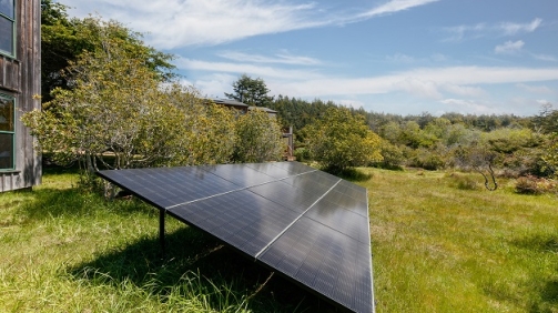 Solar panels in field by houses in California